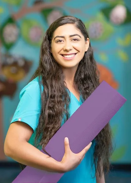 Alexxis holding a yoga mat